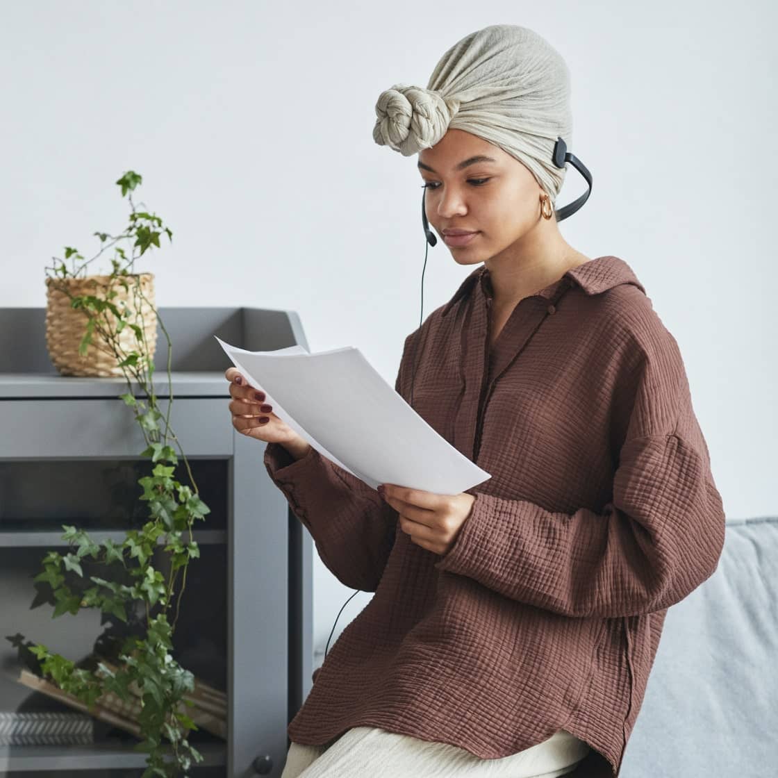 Lady in white outfit reading paper